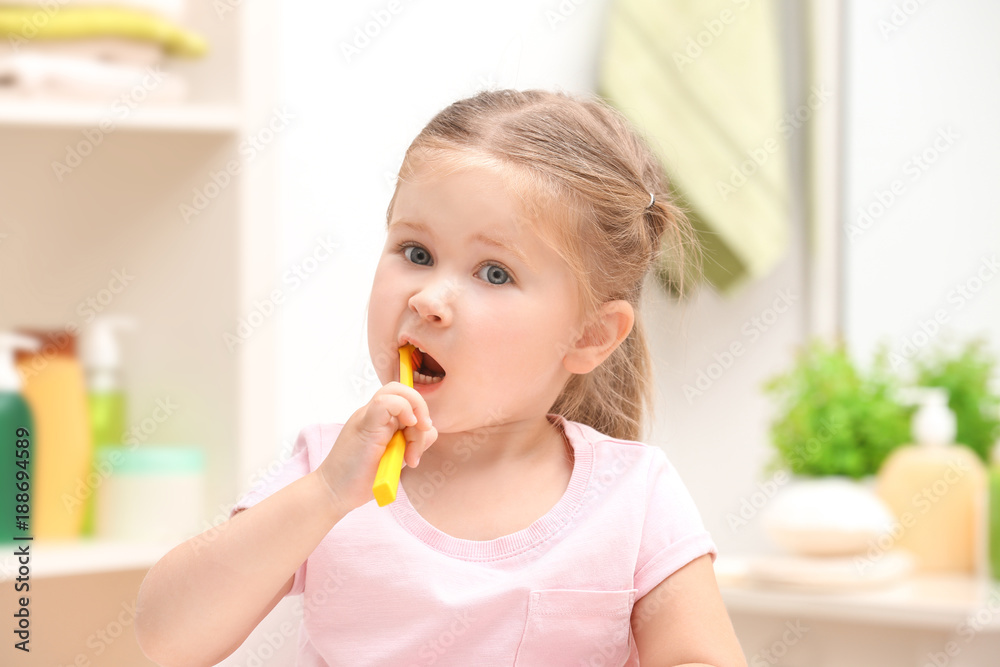 Cute little girl brushing teeth in bathroom Cute little girl brushing teeth in bathroom