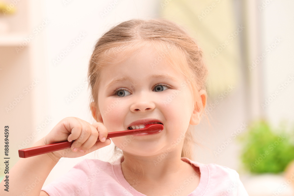 Cute little girl brushing teeth in bathroom Cute little girl brushing teeth in bathroom