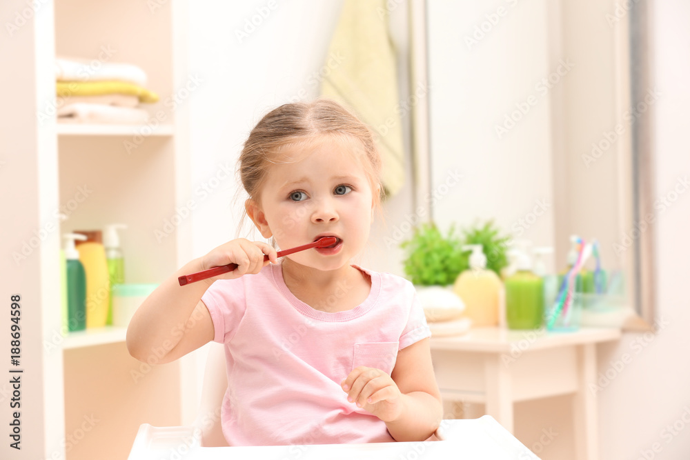 Cute little girl brushing teeth in bathroom Cute little girl brushing teeth in bathroom