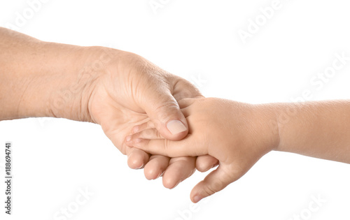 Hands of elderly man and baby on white background © Africa Studio