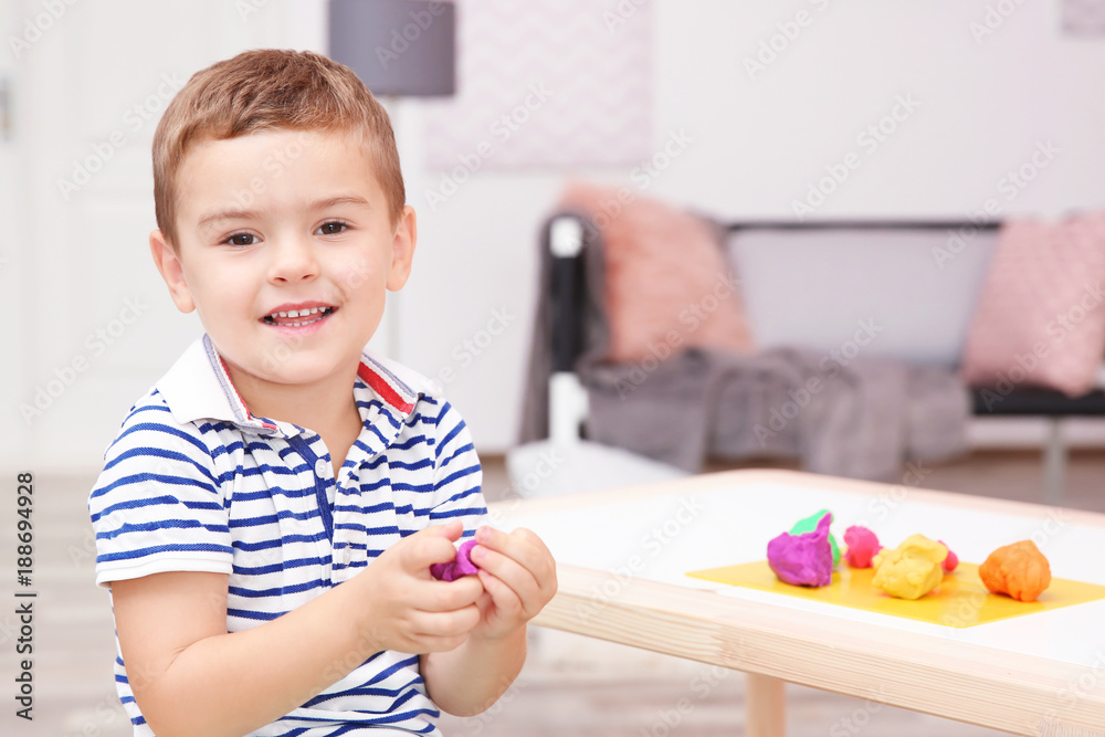 Cute little boy modeling from playdough at home Cute little boy modeling from playdough at home
