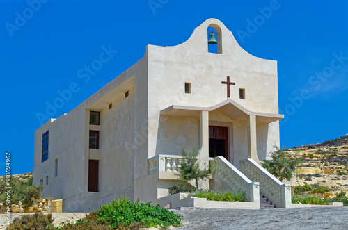 St Anne catholic chapel against clear blue sky. This chapel is located near Dwejra in San Lawrenz on the island Gozo on Malta. photo