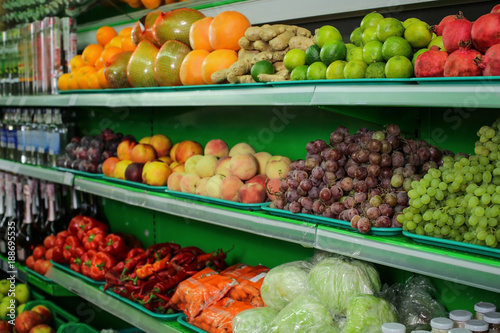 Fototapeta Naklejka Na Ścianę i Meble -  Variety of different fruits and vegetables on shelves in supermarket