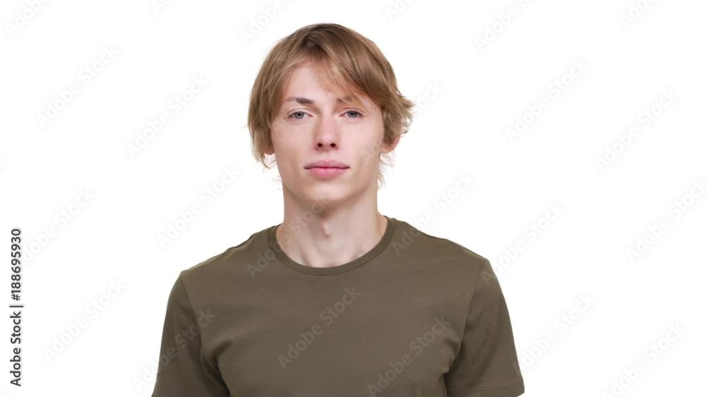 Portrait of caucasian guy in green t-shirt looking on camera being calm and glad being isolated over white background. Concept of emotions Portrait of caucasian guy in green t-shirt looking on camera being calm and glad being isolated over white background. Concept of emotions