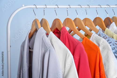 Clean clothes hanging on rack in laundry