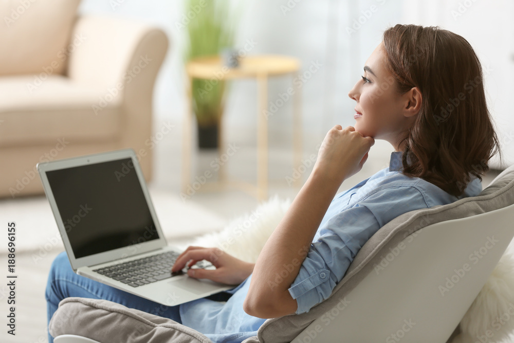 Young woman using laptop at home Young woman using laptop at home