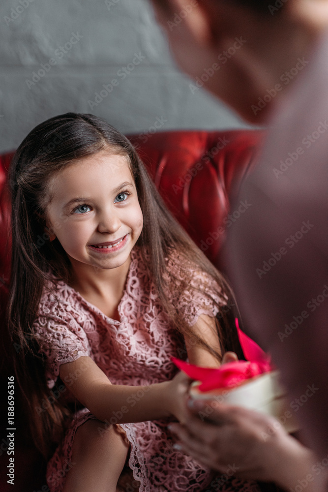 close-up shot of daughter giving present to mother for mothers day