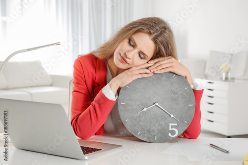 Tired manager with clock si...
