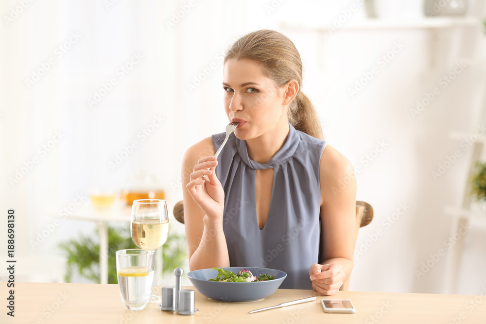 Young beautiful woman eating fresh salad at home Young beautiful woman eating fresh salad at home