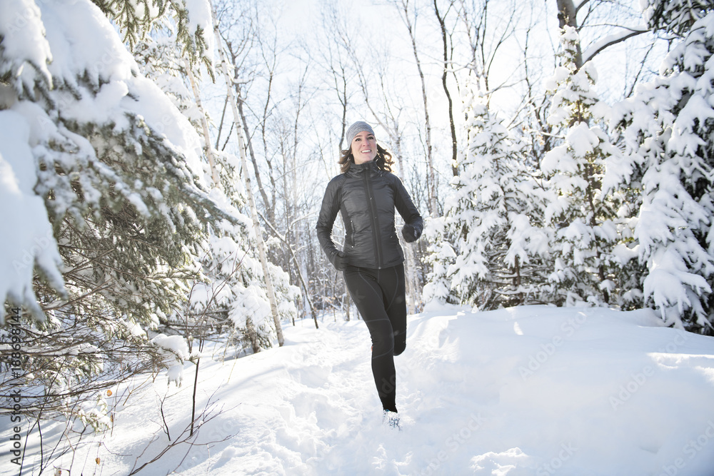 Woman Running in Snowy Park