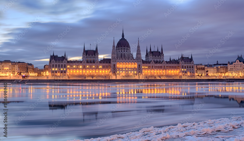 Fototapeta premium Winter twilight view of Budapest Parliament building over frozen Danube river