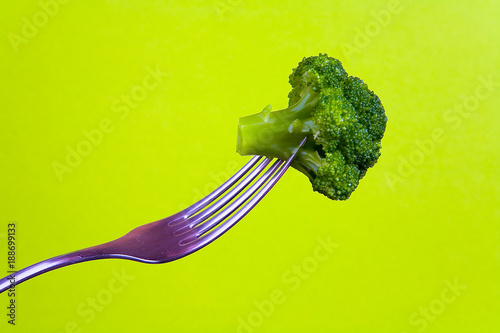 Broccoli is planted on a metal fork.