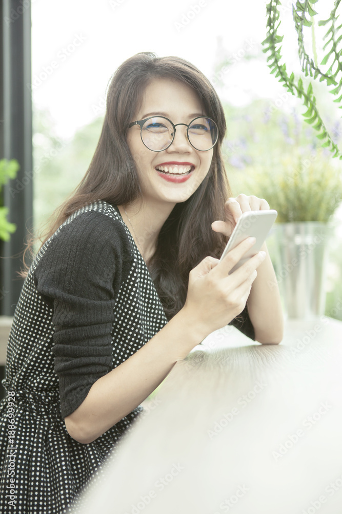 beautiful asian woman laughing face happiness emotion with smart phone in hand beautiful asian woman laughing face happiness emotion with smart phone in hand