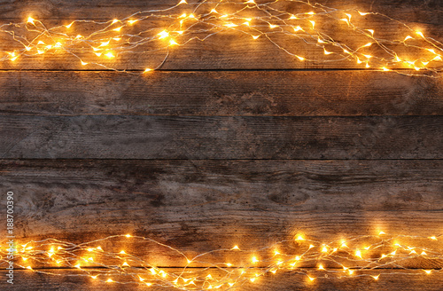 Festive christmas lights on wooden background