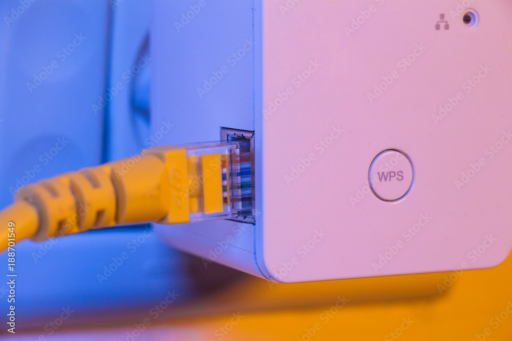 WiFi extender in electrical socket on the wall with ethernet cable plugged  in Stock Photo | Adobe Stock