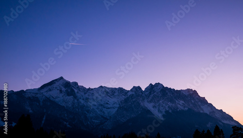 plane flying over a mountain during dusk - astounding sky