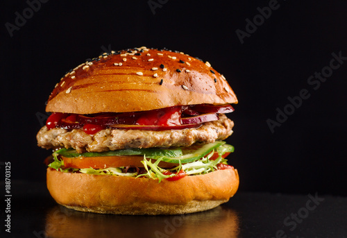 Hamburger on a black slate board.