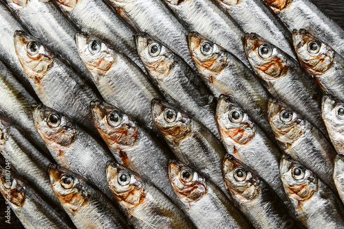 fresh raw fish anchovy and sprat on a wooden surface