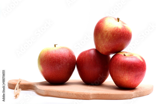Apples on board isolated on white background.