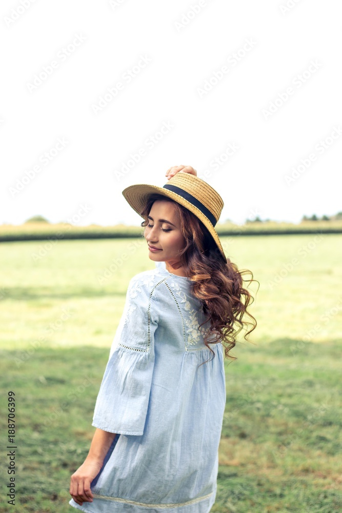 Young beautiful woman is walking in the park. Summer. A girl is walking in the spring. Field.