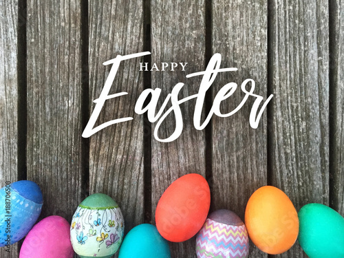 Wallpaper Mural Happy Easter Calligraphy Text Message with Colorful Decorated Eggs Over Rustic W
