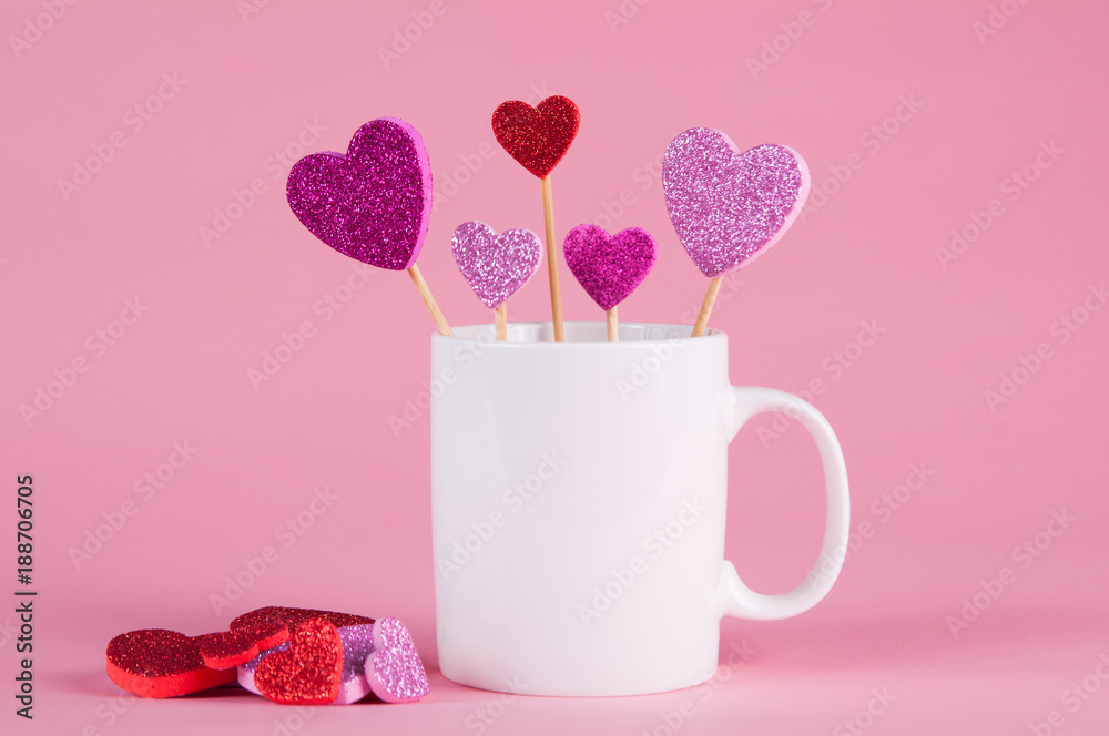 White mug on a pink background with hears for Valentine's day White mug on a pink background with hears for Valentine's day