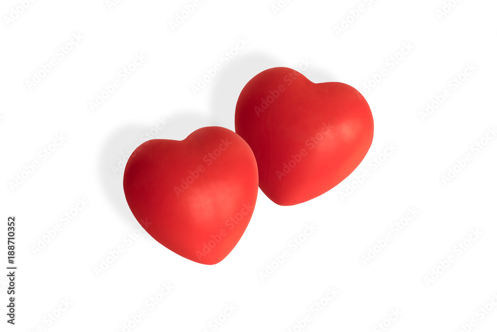 Two soft touch red hearts isolated on white background with drop shadow.