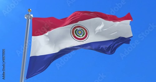 Flag of Paraguay waving at wind with blue sky in slow, loop photo