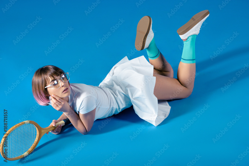 Cadeau vrede Vertrouwelijk sexy Female tennis player lying with tennis racket and looking away on blue  Stock Photo | Adobe Stock