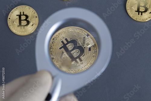 Bitcoin with a magnifying glass