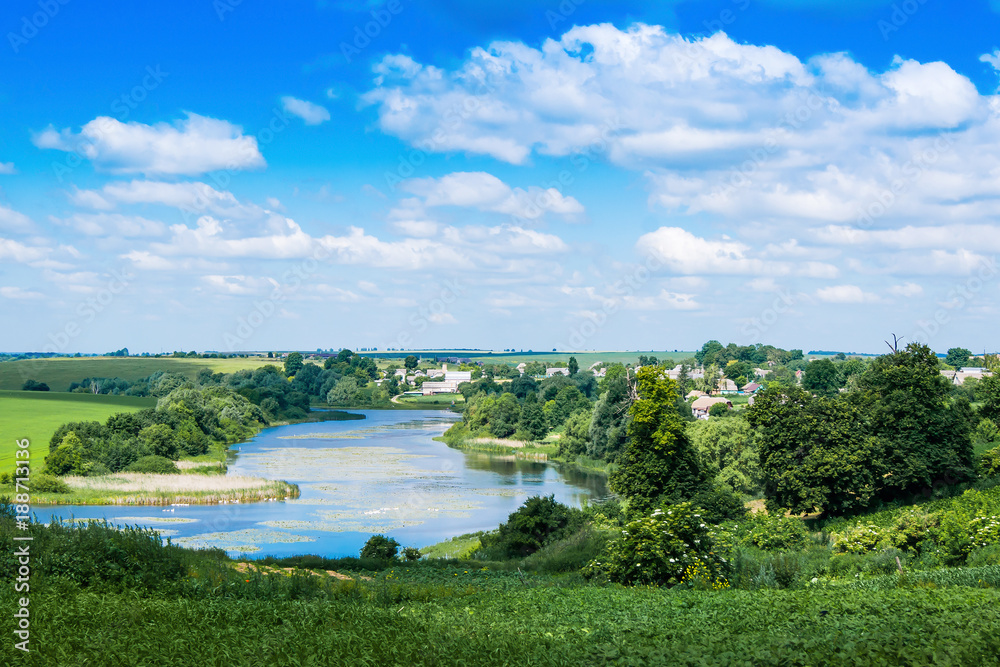 summer landscape, seen river, trees and clear blue sky with clouds