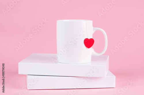 mug of tea with a heart on a pink background