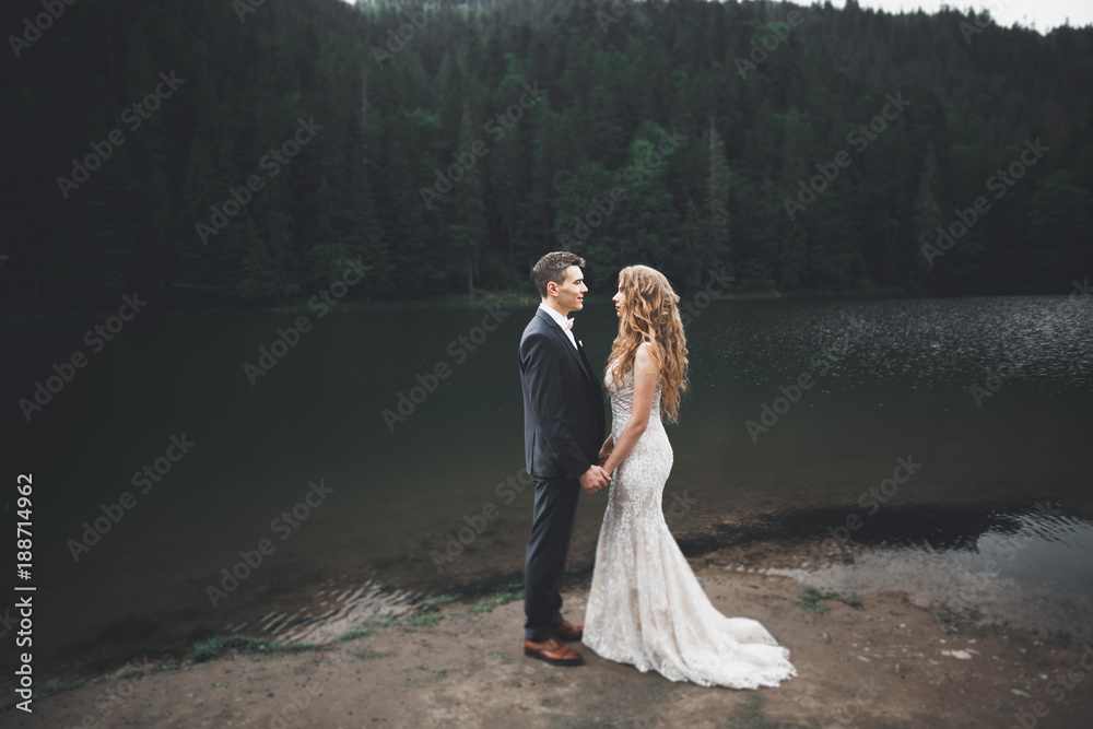 Perfect couple bride, groom posing and kissing in their wedding day Perfect couple bride, groom posing and kissing in their wedding day