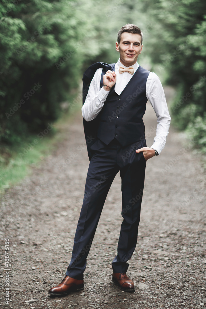 Young handsome man posing on mountain forest Young handsome man posing on mountain forest