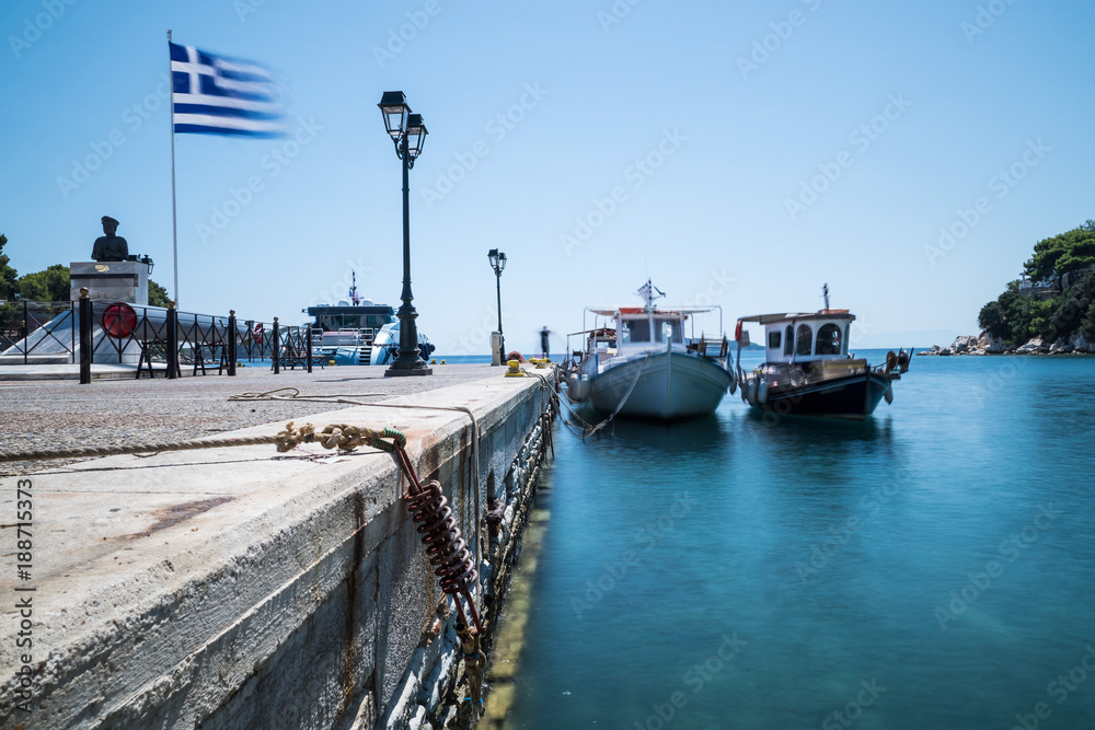 boats and greek flag in Skiathos, Greece