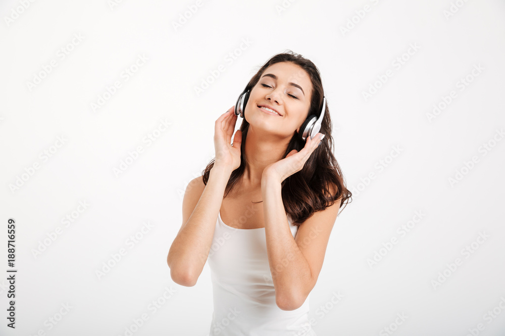 Portrait of a girl dressed in tank-top listening to music Portrait of a girl dressed in tank-top listening to music
