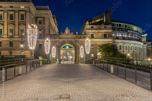 Rikstagshuset i Stockholm på natten sett från Drottninggatan med Riksbron i förgrunden photo