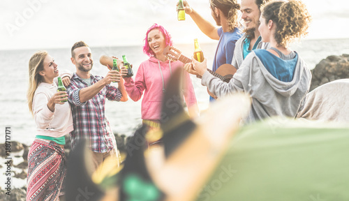 Group of happy friends cheering with beers in camping