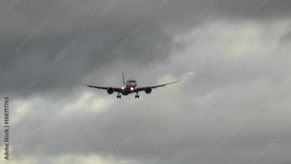 An airplane approaches runway Northwest of Airport Frankfurt, Germany during strong winds - low-angle view An airplane approaches runway Northwest of Airport Frankfurt, Germany during strong winds - low-angle view