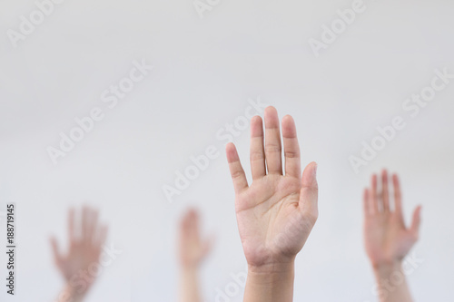 Raise hand with blurry background