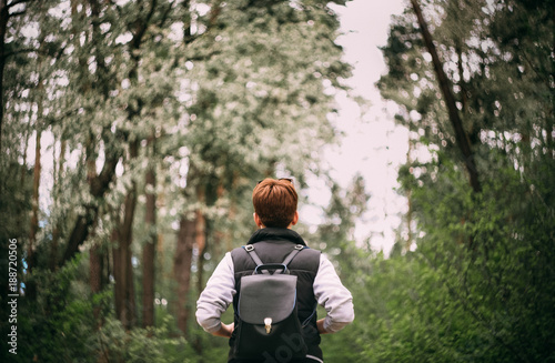 short-haired girl with a backpack for a walk in a forest