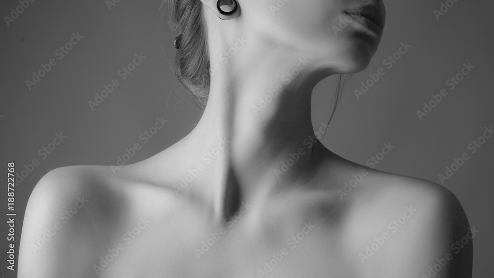 Shoulders and neck of a beautiful woman. Black and white - obrazy, fototapety, plakaty 