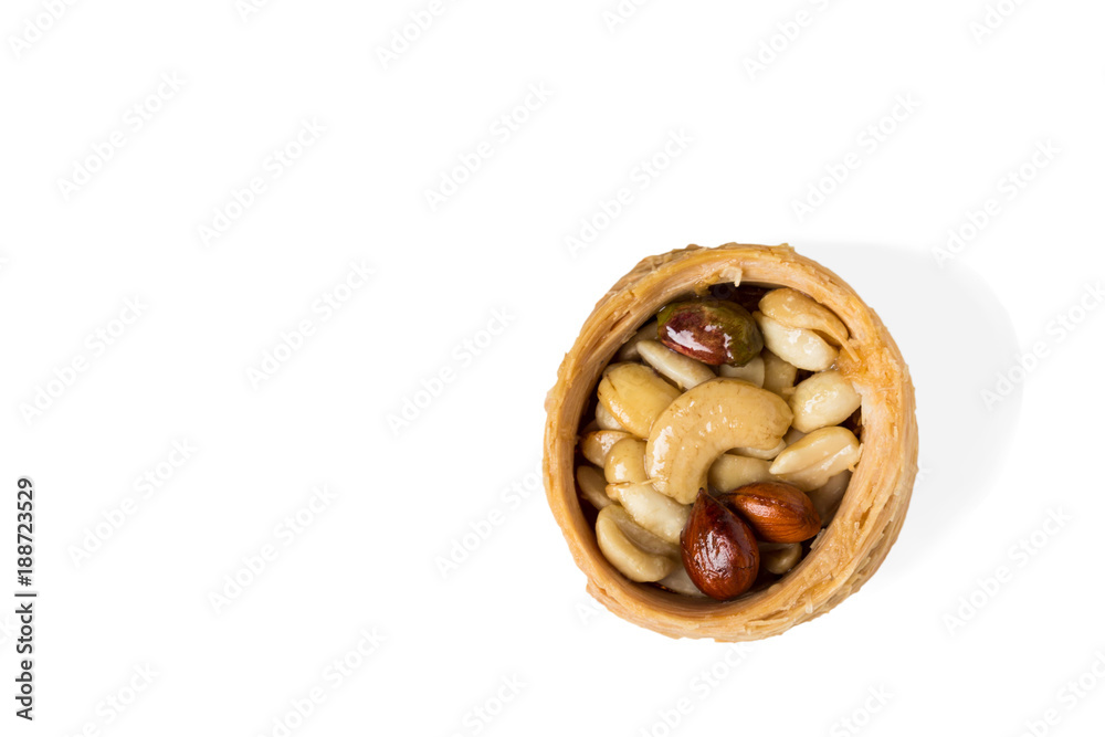 Traditional arabic dessert Kunafa with honey and nuts, selective focus Traditional arabic dessert Kunafa with honey and nuts, selective focus