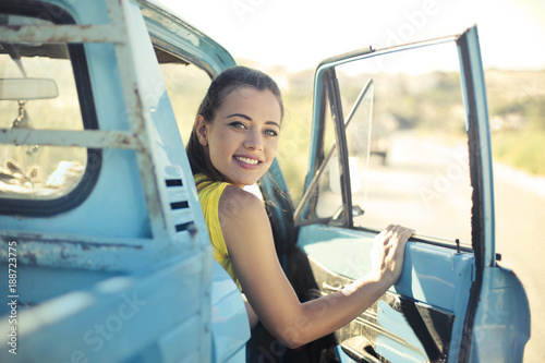 Smiling girl on an old truck