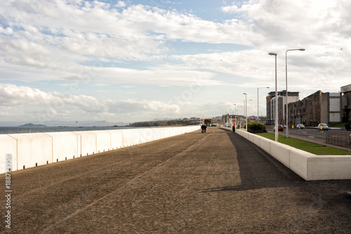 Sea front promenade in the town of Kirkcaldy, Scotland, people walking at a distance