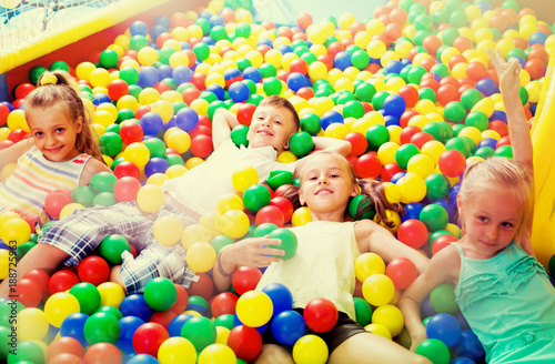 kids playing with multicolored plastic balls .