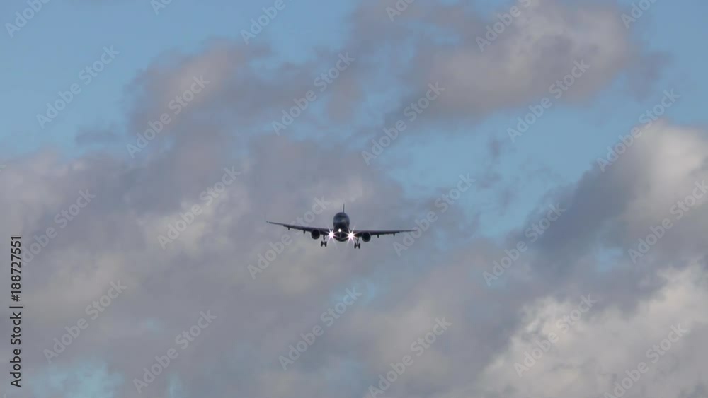 An airplane approaches runway Northwest of Airport Frankfurt, Germany during strong winds - low-angle view An airplane approaches runway Northwest of Airport Frankfurt, Germany during strong winds - low-angle view