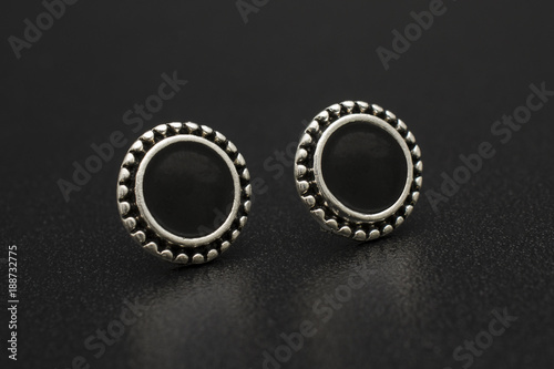 silver stud earrings isolated on black