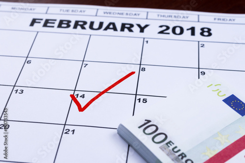 February 14 marked on the calendar and the money set aside for gifts.