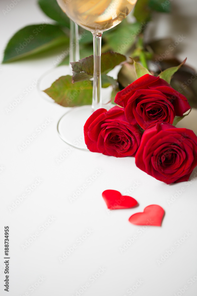 Romantic date champagne white wine glasses red beautiful roses, gift jewelry box and heart shape decoration. Valentine`s day date dinner engagement marriage proposal international women day concept Romantic date champagne white wine glasses red beautiful roses, gift jewelry box and heart shape decoration. Valentine`s day date dinner engagement marriage proposal international women day concept